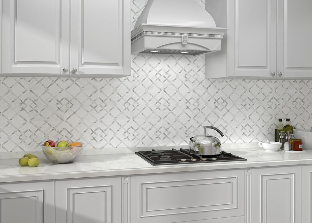 White kitchen with patterned tile backsplash, stainless steel appliances, and fruit bowl.