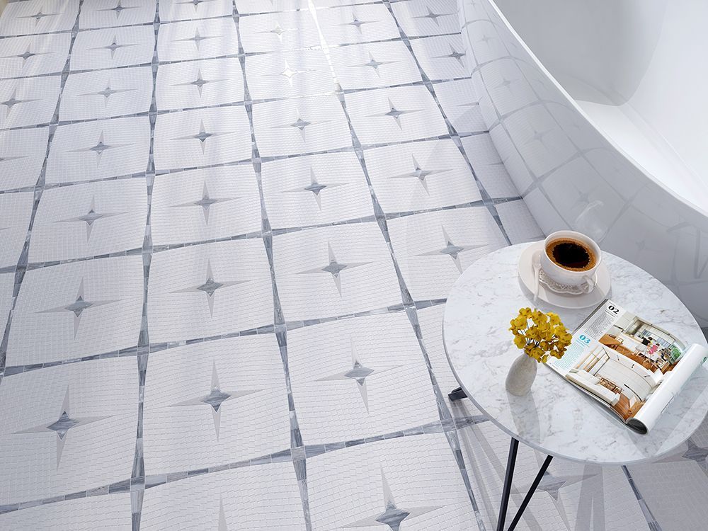White and gray starburst tile floor in a bright bathroom, a small table with coffee and magazine.