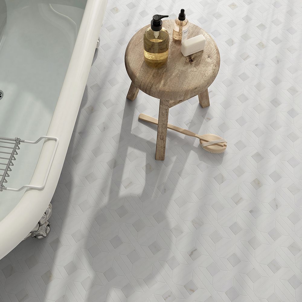 Bathroom with white tile floor, bathtub, wooden stool with toiletries, and a decorative oar.