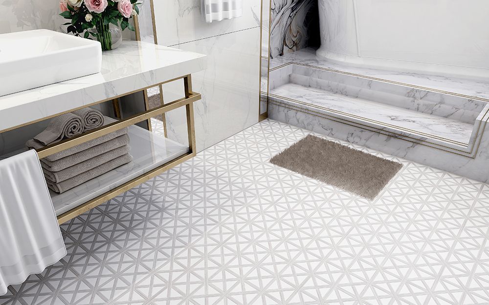 Elegant bathroom with white marble accents, gold trim, and patterned tile floor.
