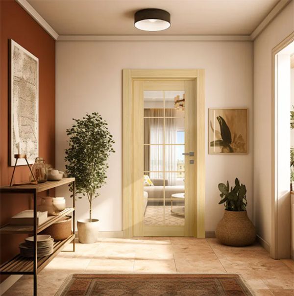 Hallway with a wooden door, art, and a potted plant; terracotta and cream colors.