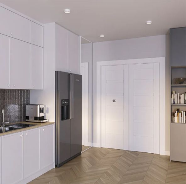 Modern kitchen with white cabinets, gray refrigerator, and wooden floors.