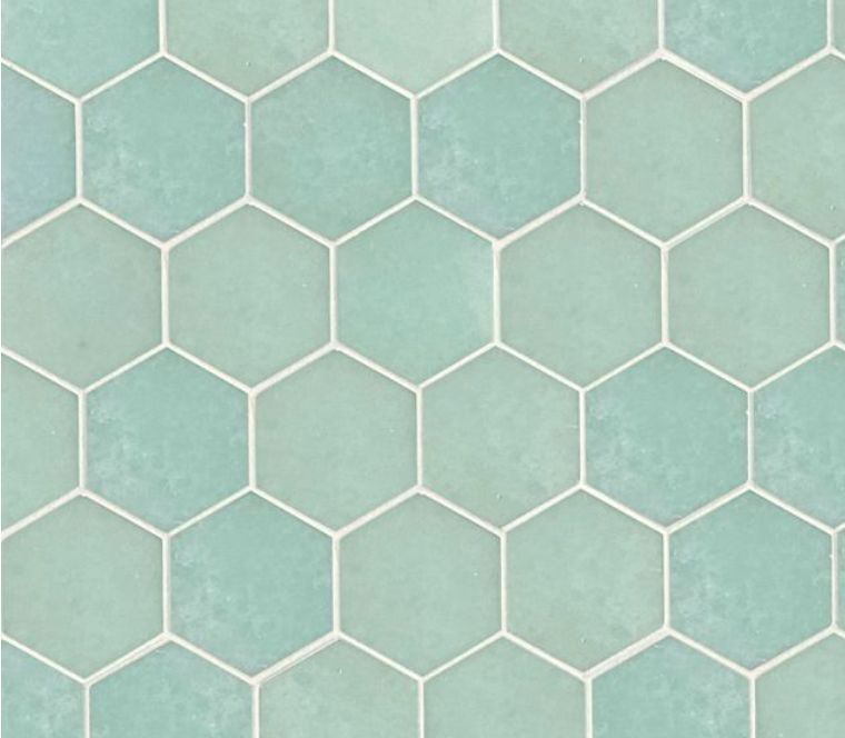 Light turquoise hexagon tiles with white grout.