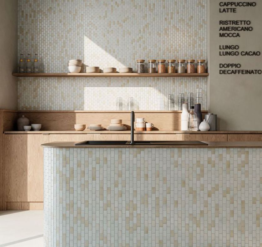 Kitchen with light wood cabinets, mosaic tile walls, and a menu board listing coffee drinks.