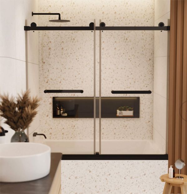 Modern bathroom with a bathtub, black shower door, and speckled tile.