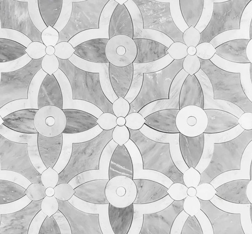 Black and white marble floor pattern with floral motifs.