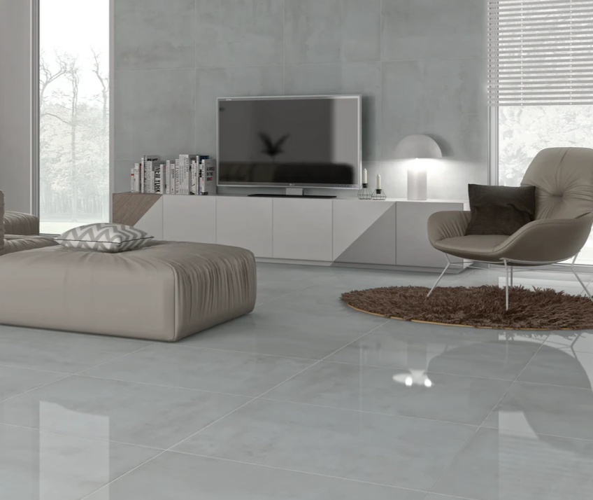 Living room with gray glossy floor and walls, modern furniture, TV, window, and rug.