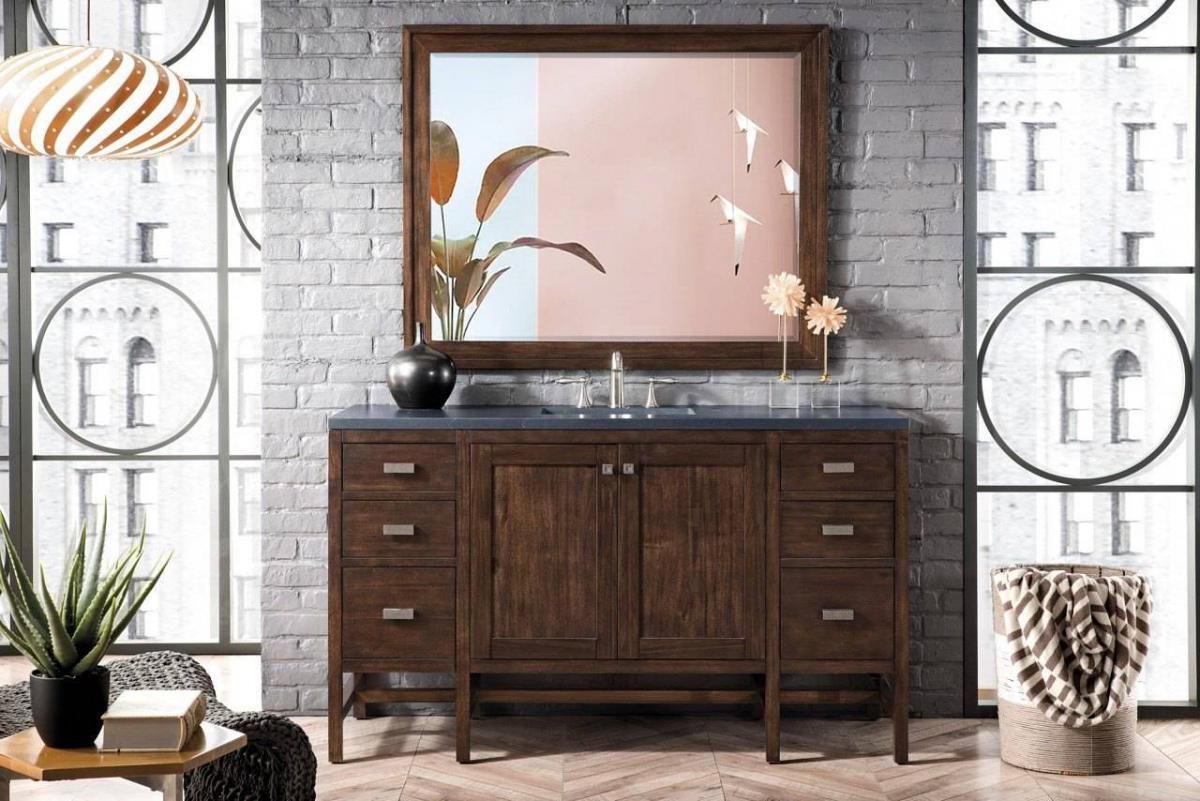 Bathroom vanity with a dark wood cabinet, mirror, and window with city view.