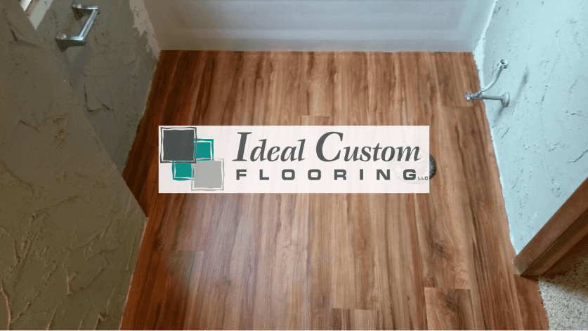 Ideal Custom Flooring sign on wood floor in a room under renovation