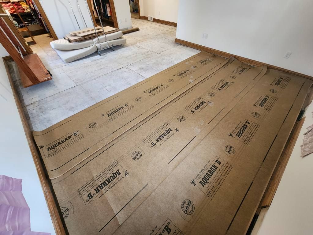 Living room floor under renovation with cardboard and protective flooring laid down