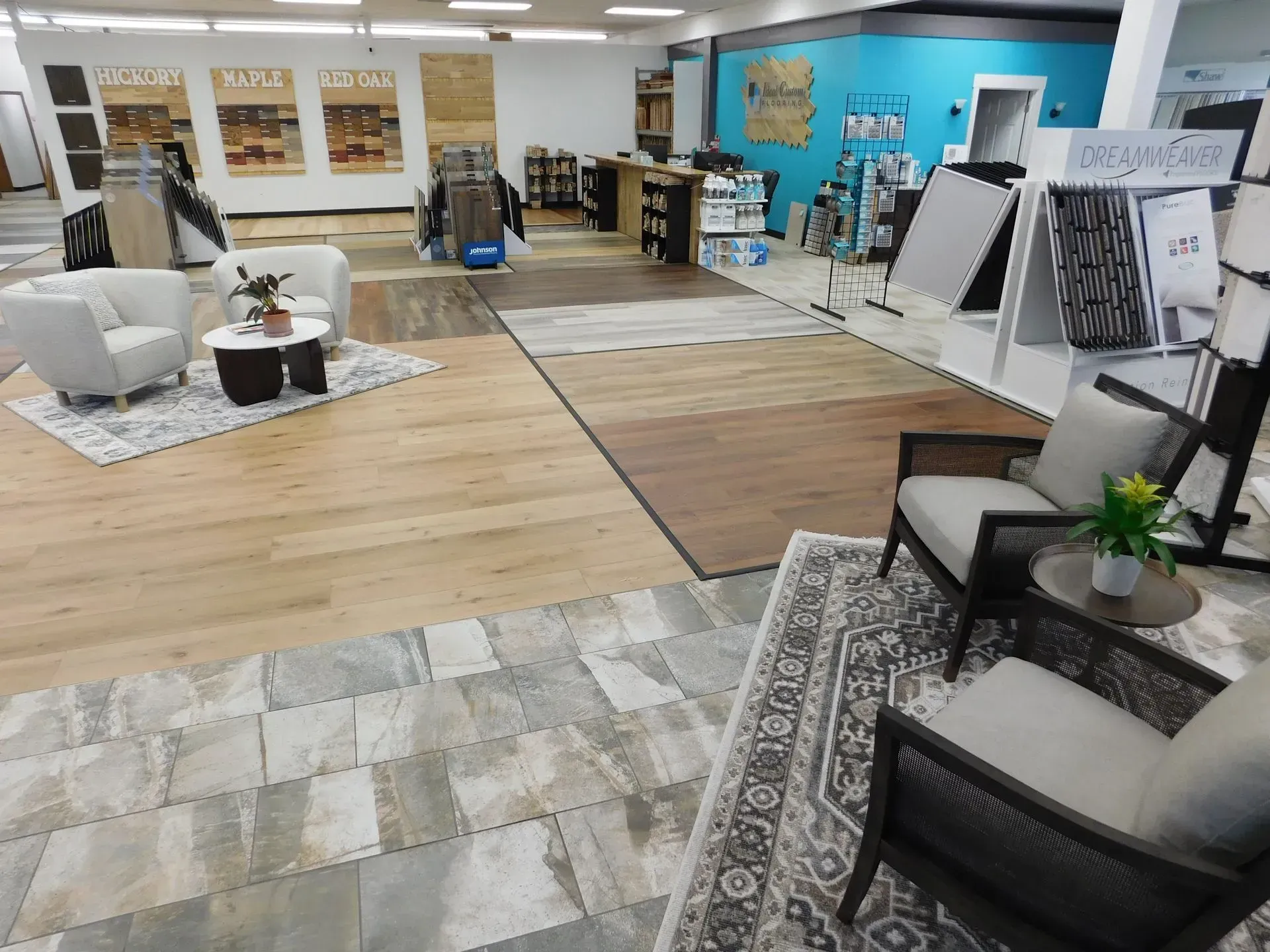 Furniture showroom with rugs, chairs, sofas, and displays in a bright open space