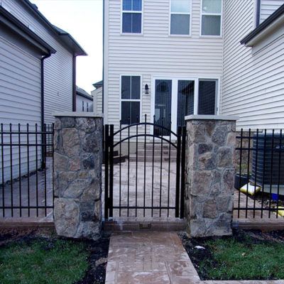 A house with a stone walkway and a metal gate