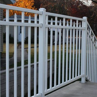 A white fence with a house in the background