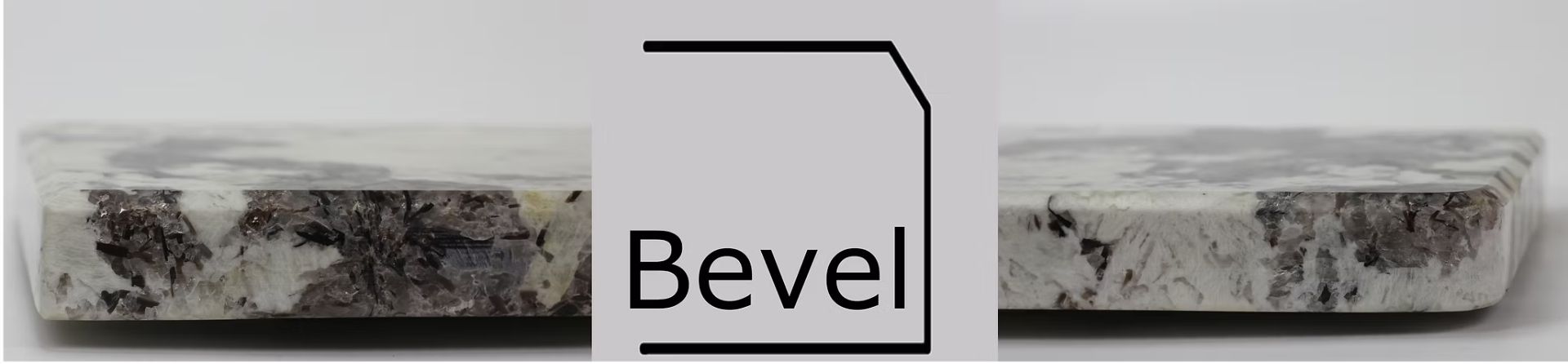 A beveled edge on a light-colored, patterned stone tile.