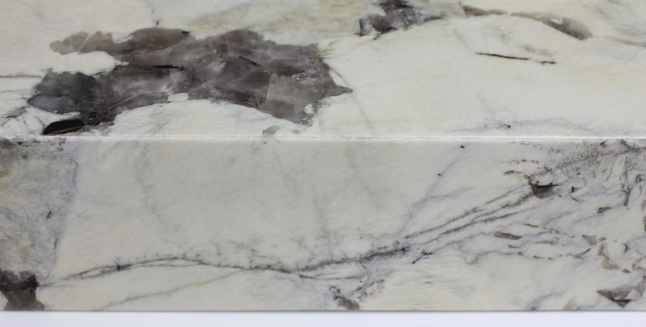 Close-up of a white marble countertop with gray and black veining.
