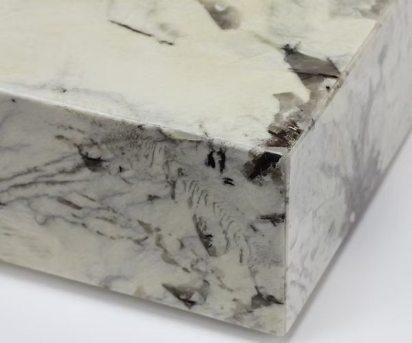 White and gray marble countertop with dark veining and a smooth, polished finish.