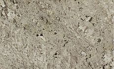 Light tan, textured stone surface with various dark and light specks, swirls, and holes.