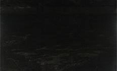 Dark, textured surface, possibly stone or marble. Swirls and variations in tone are visible.