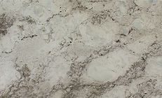 Creamy white and gray marbled stone surface with dark veining.