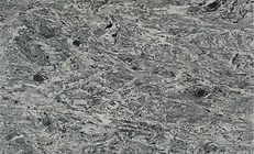 Gray and white stone surface with swirling patterns and dark specks.