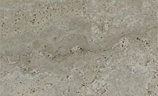 Textured, light brown travertine stone with small holes and flowing patterns.