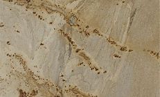Beige and brown granite countertop with natural veining and speckled details.