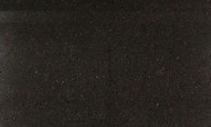 Dark, granular surface with subtle horizontal lines.