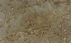 Close-up of a tan and brown granite slab with swirling patterns and dark speckles.