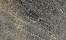 Gray and brown stone surface with diagonal streaks and variations in color.