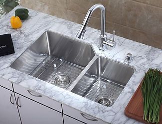 Stainless steel kitchen sink with two basins, a high faucet, and marble countertop.