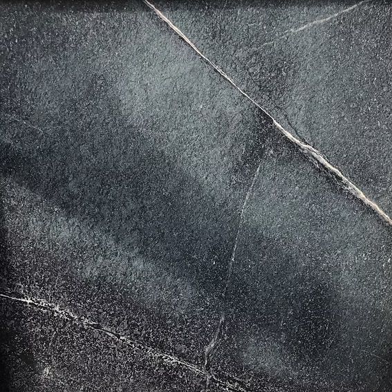 Dark gray surface with white veining.