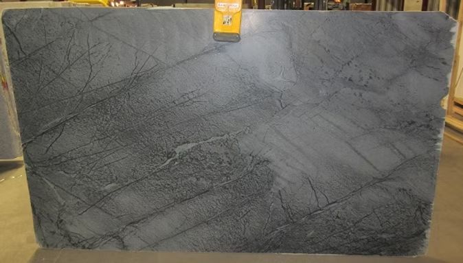 Gray granite slab with dark veining, possibly for countertops or surfaces.