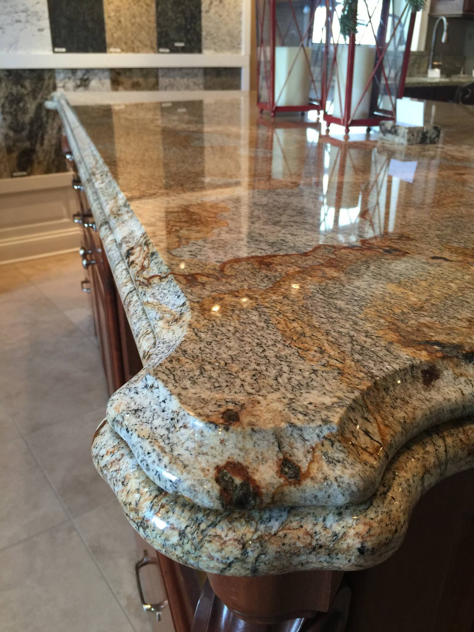 Close-up of a granite countertop with a decorative edge; beige, brown, and black speckled pattern; polished surface.