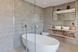 Luxurious looking bathroom with oval bathtub and sinks