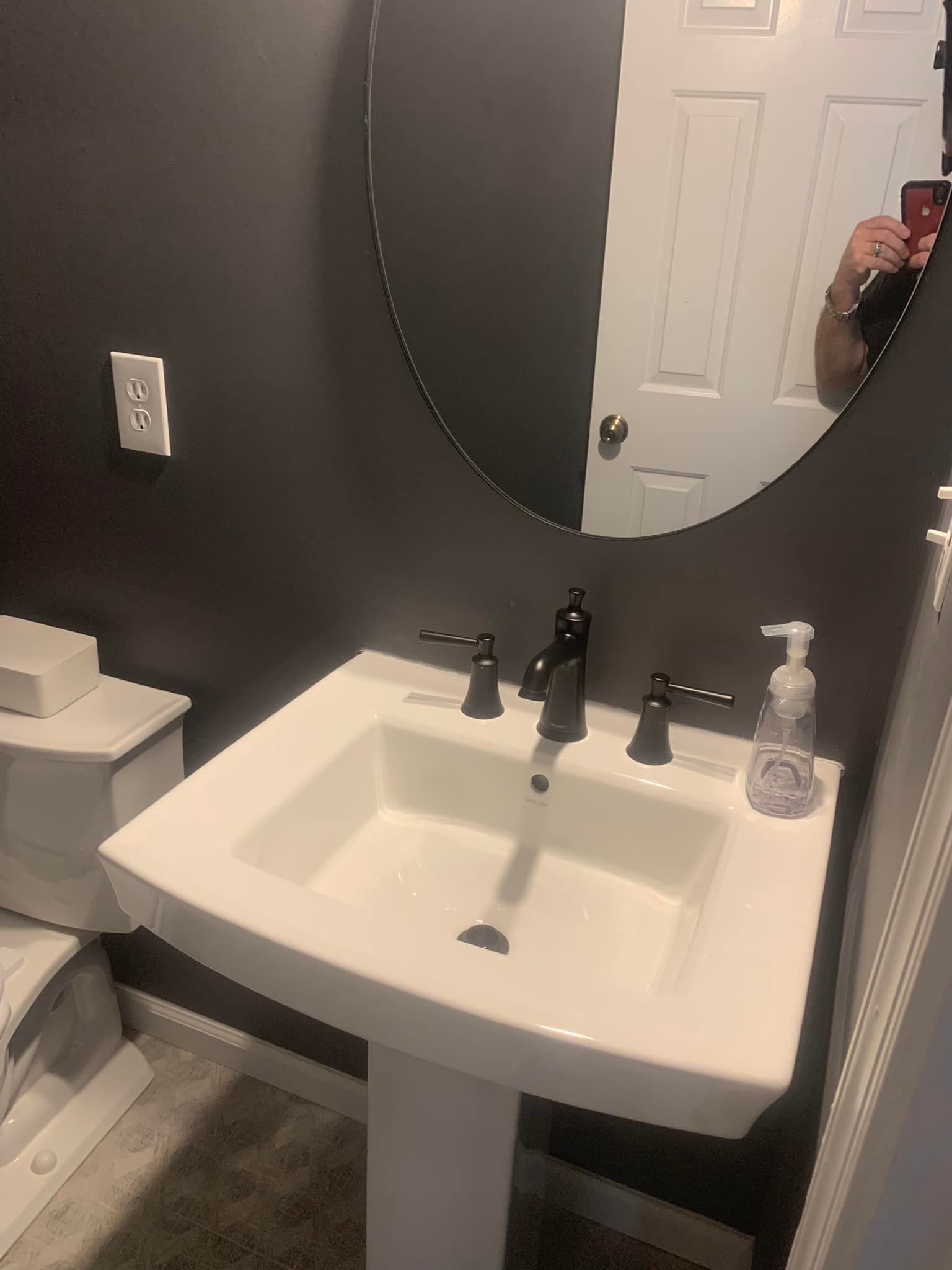 Bathroom sink and round mirror