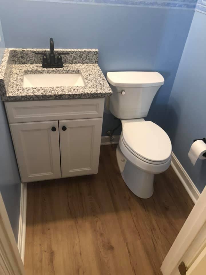Bathroom sink cabinet beside toilet