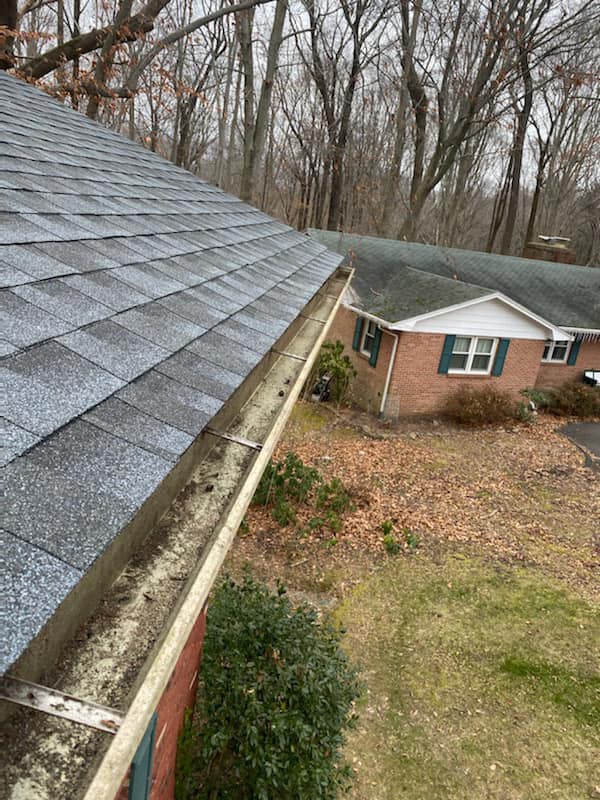 Grey shingle roof with gutter