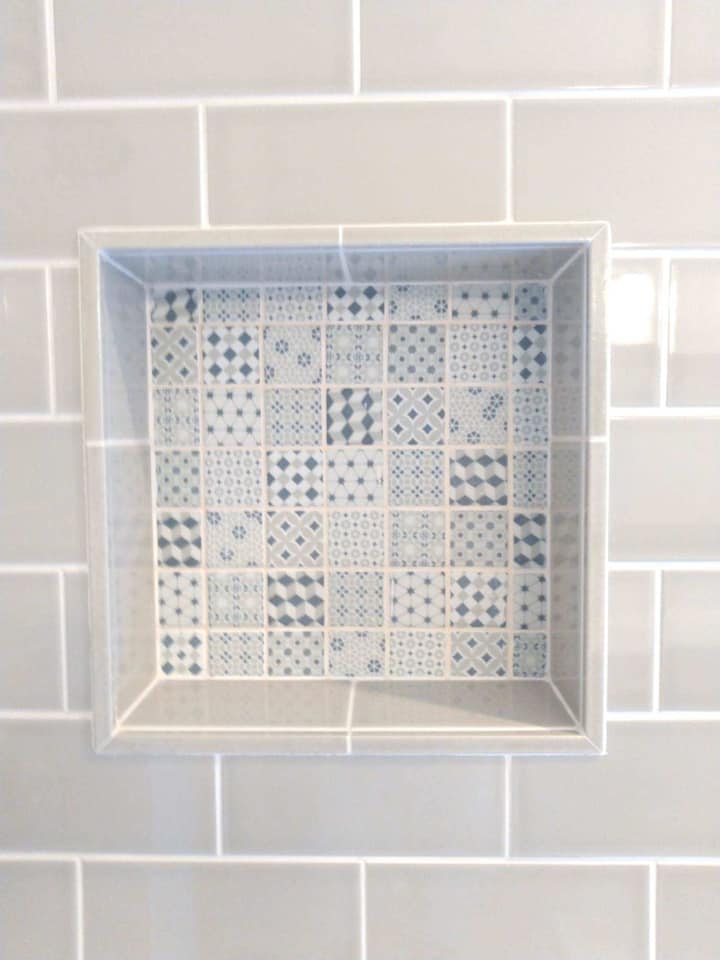 Recessed soap holder on tiled shower area