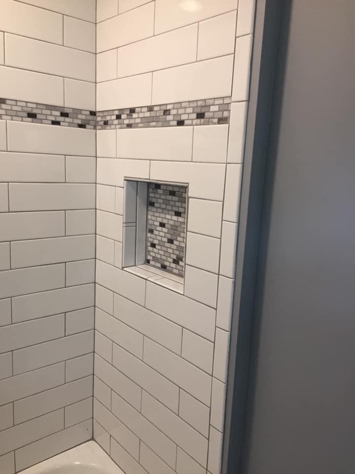 Recessed soap holder on tiled shower area
