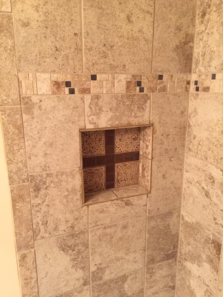 Recessed soap holder on tiled shower area
