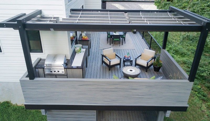 An aerial view of a deck with a pergola and a grill.