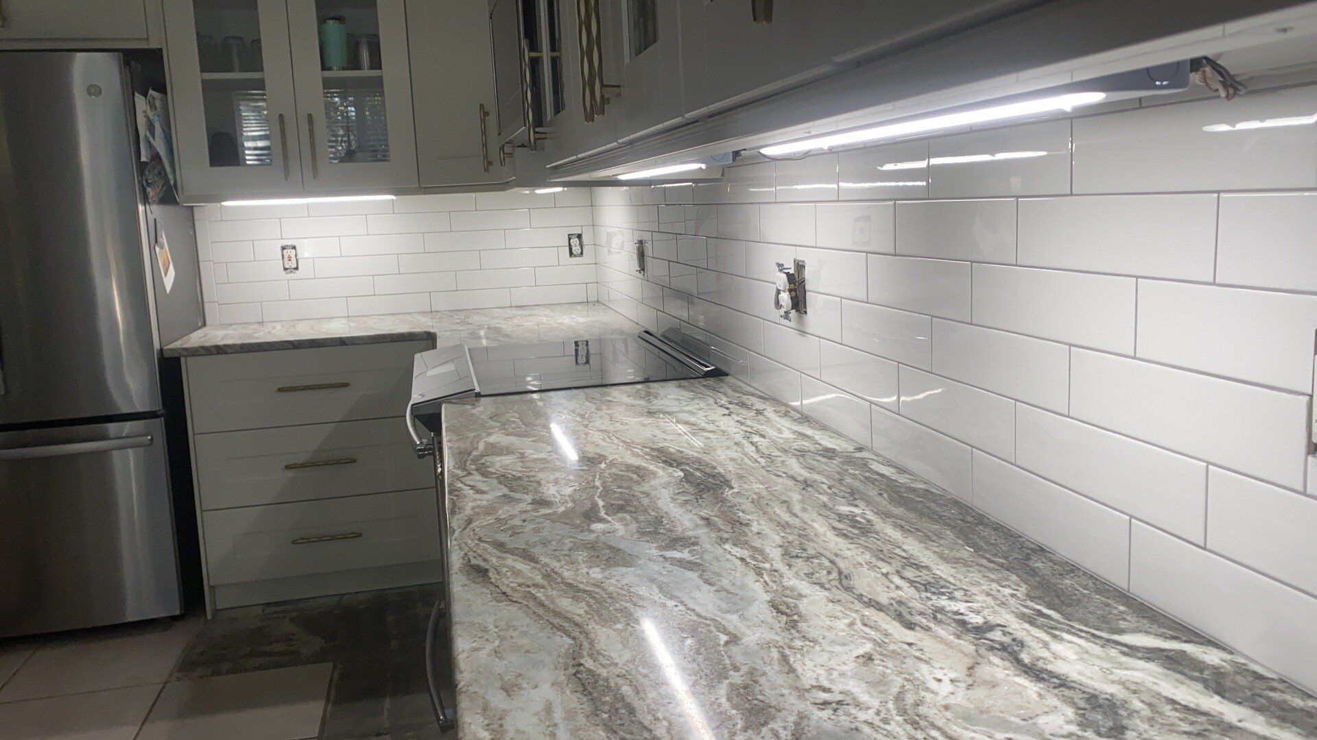 A bathroom vanity with gray cabinets and drawers is being built.