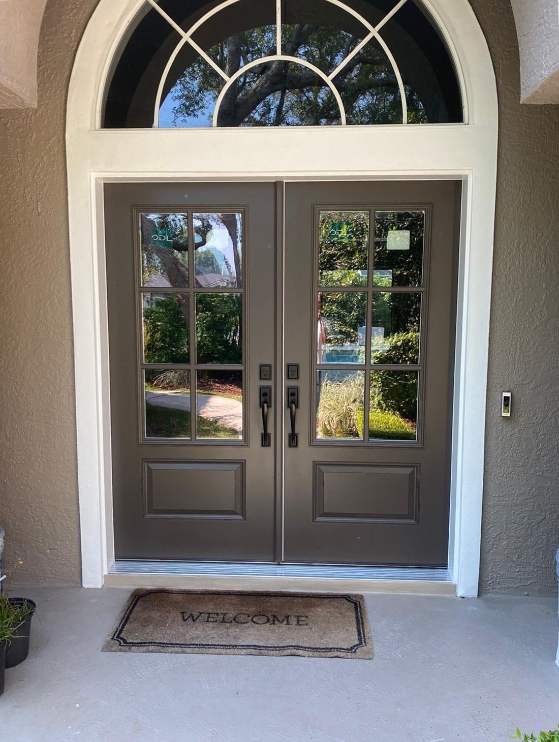 The front door of a house with a welcome mat on the floor