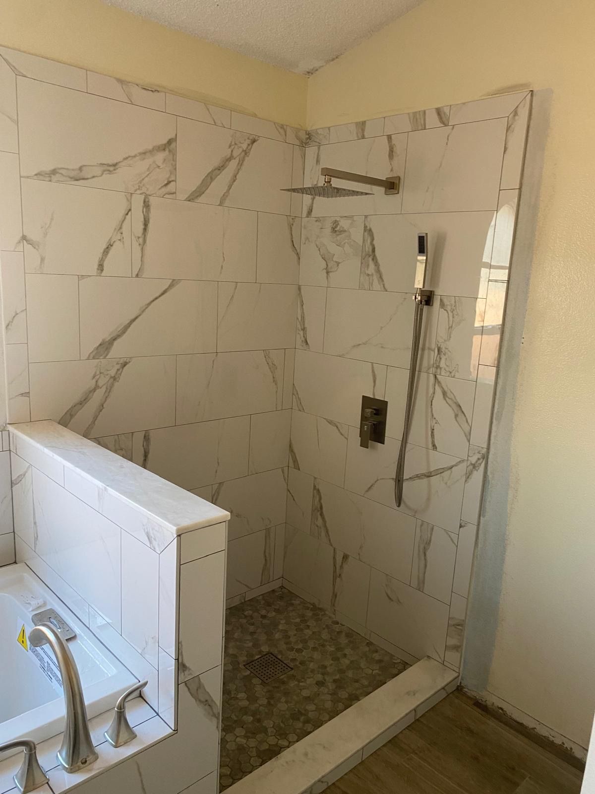 A bathroom with a walk in shower