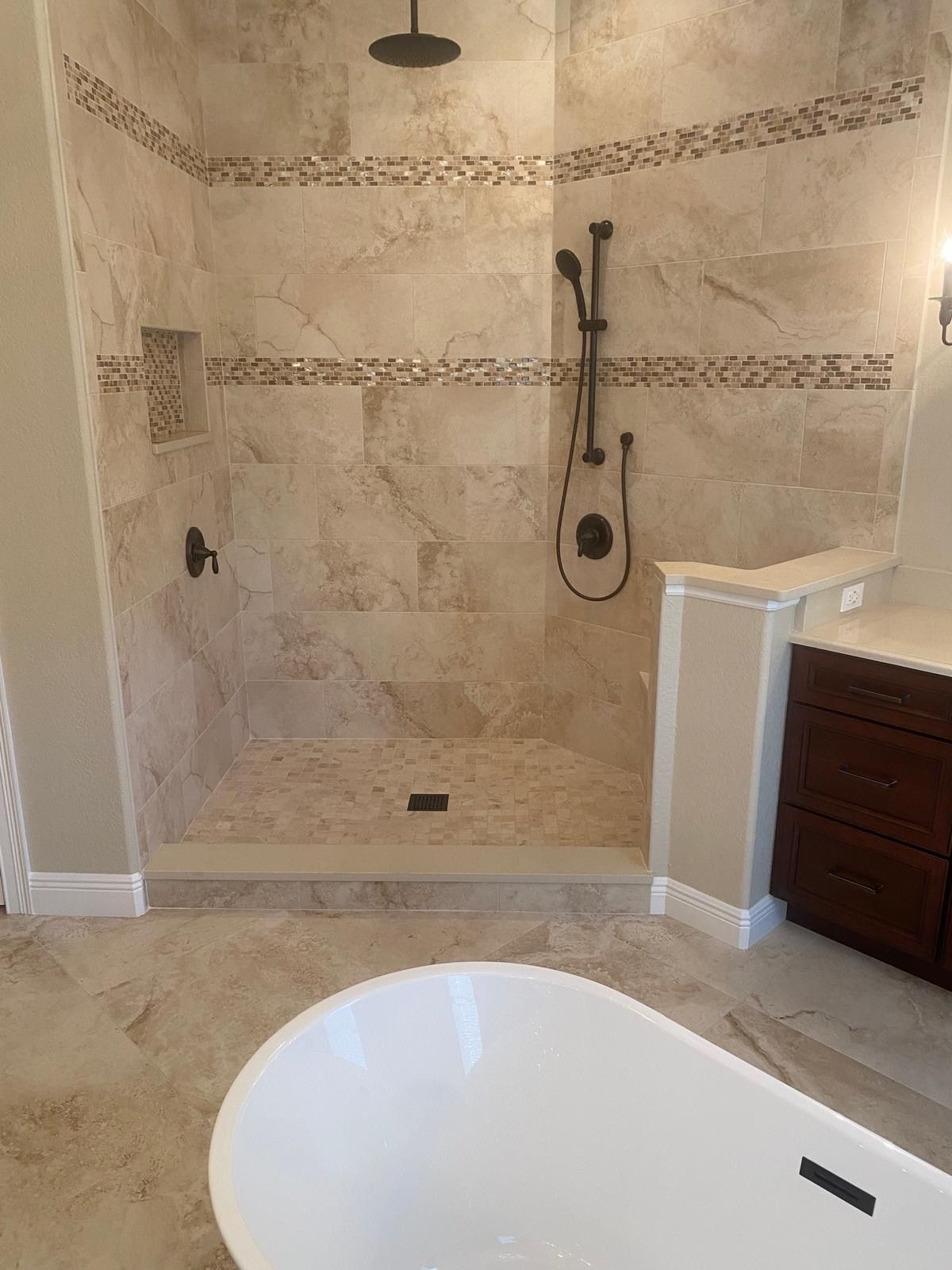 A bathroom with a walk in shower and a bathtub