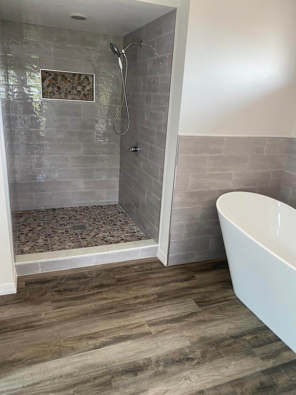 A bathroom with a walk in shower and a bathtub