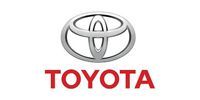 Toyota logo with silver emblem above red text.