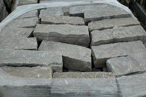 A pile of bricks wrapped in plastic is sitting on top of each other.