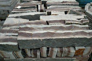 A pile of rocks sitting on top of each other on top of a fence.