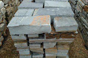 A pile of bricks stacked on top of each other on top of a pile of gravel.